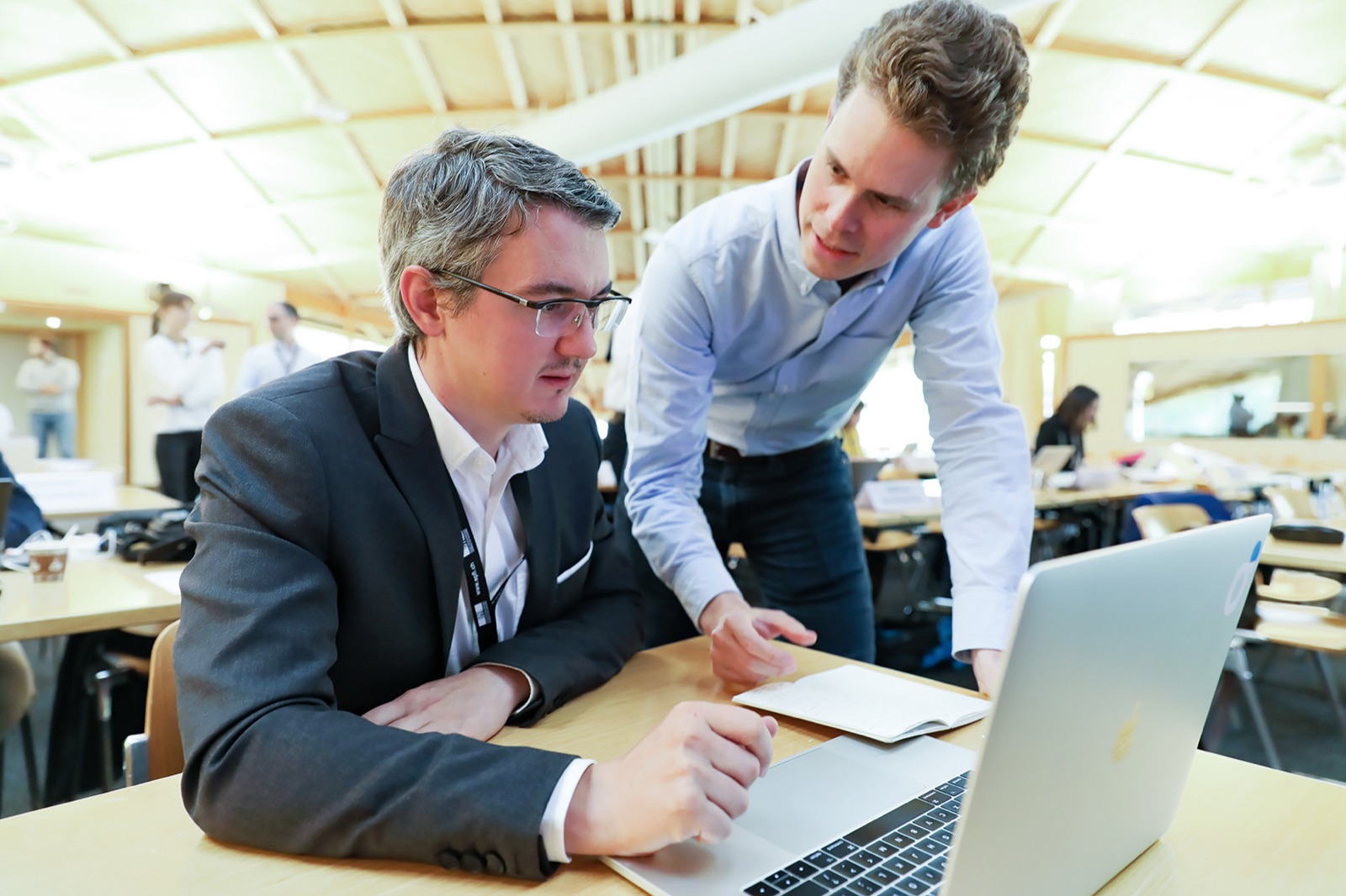 Hands-on coaching during a workshop - an instructor works one-on-one with a participant at a laptop